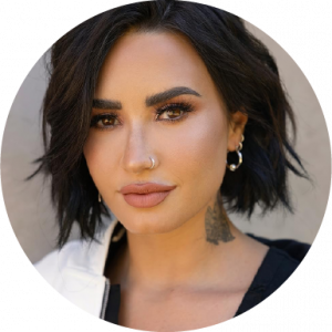 Demi Lovato slightly smiling in headshot on a neutral background
