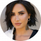 Demi Lovato slightly smiling in headshot on a neutral background