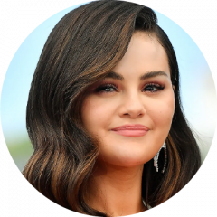 Selena Gomez smiling in headshot outdoors