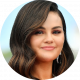 Selena Gomez smiling in headshot outdoors