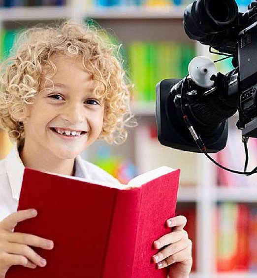 child reading in front of camera