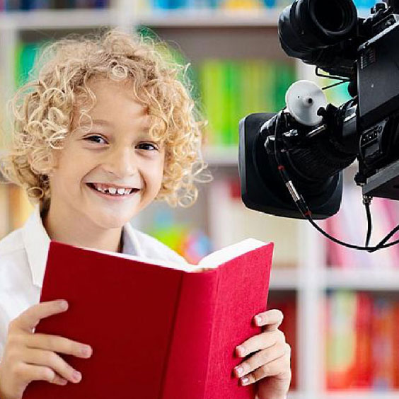 child reading in front of camera