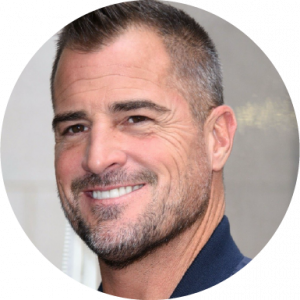 George Eads smiling in profile in a headshot on a white background
