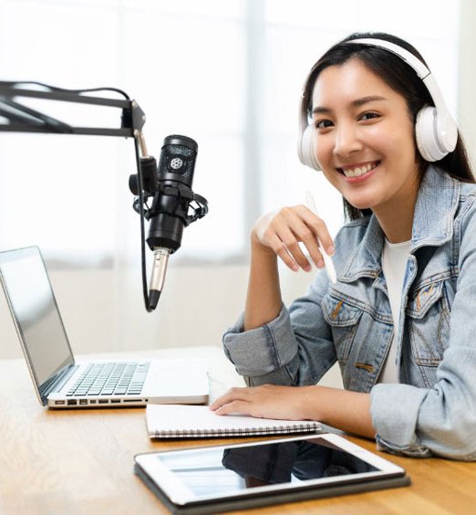 teen girl in front of microphone with headphones on