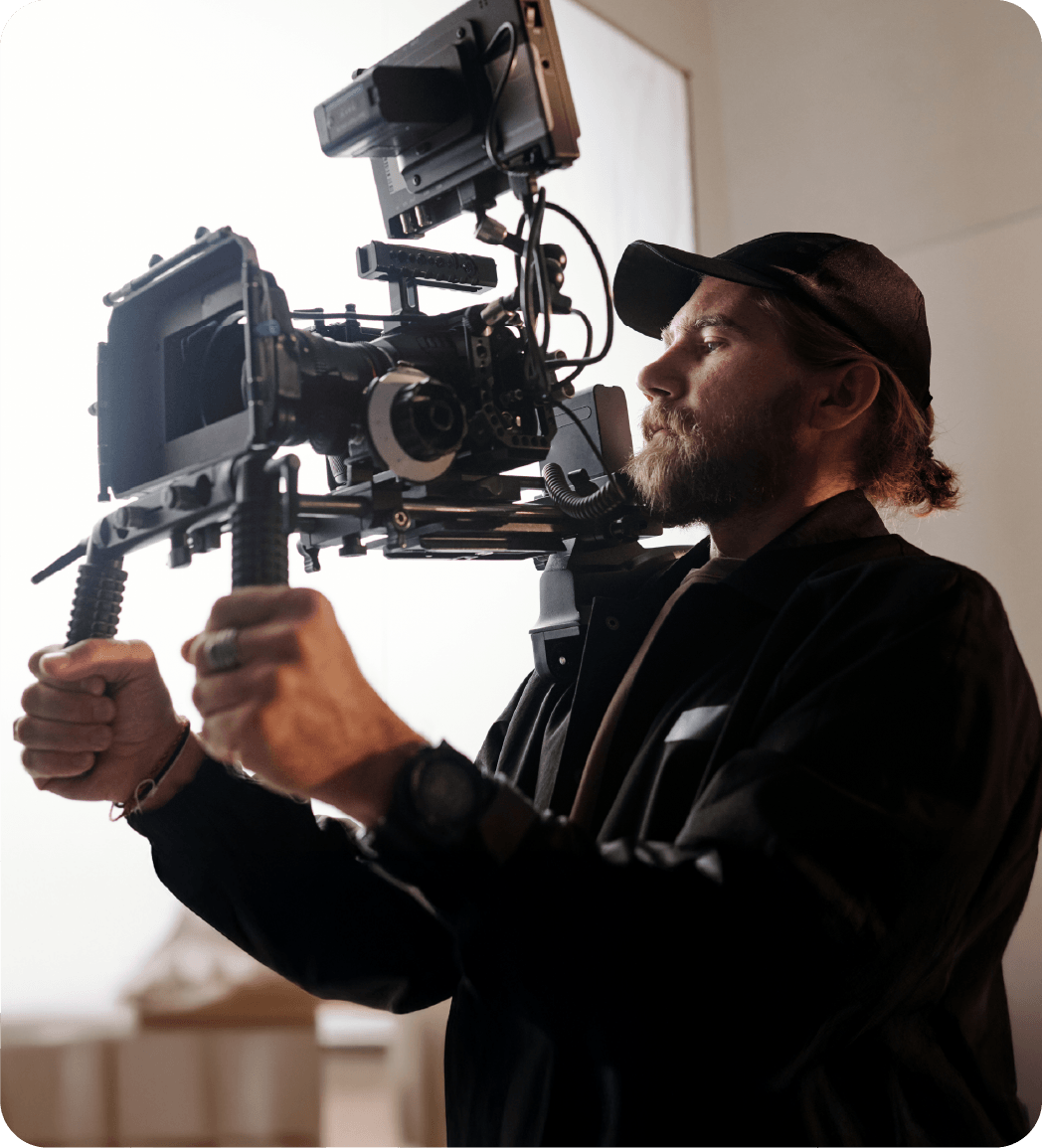 A film maker looking into his camera as he films